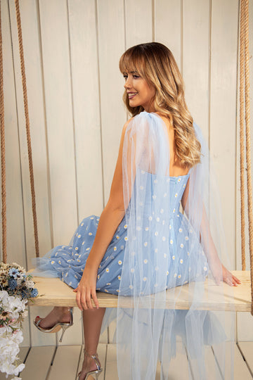 Our signature Baby Blue Daisy Dress is a  must-have from our collection. Elongated functional ties are fastened into bows at the shoulders with adjustable laces front. Zipper closure at center back.  Slip it on for a casual hang or dressed up for an evening under twinkle light.